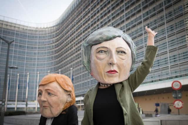 Anti Brexit protesters dressed as Theresa May and Angela Merkel outside the EU Commission in Brussels ahead of the European Leaders' summit at which Prime Minister Theresa May will be asking for an extension to Brexit. Picture: Stefan Rousseau/PA Wire