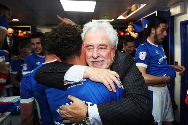 Iain McInnes embraces Kyle Bennett following Pompey's dramatic League Two title triumph. Picture: Joe Pepler/Digital South