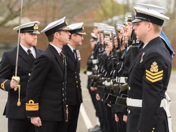 Rear Admiral Will Warrender, flag officer sea training, inspected the ceremonial guard at HMS Collingwood. Photo: Keith Woodland