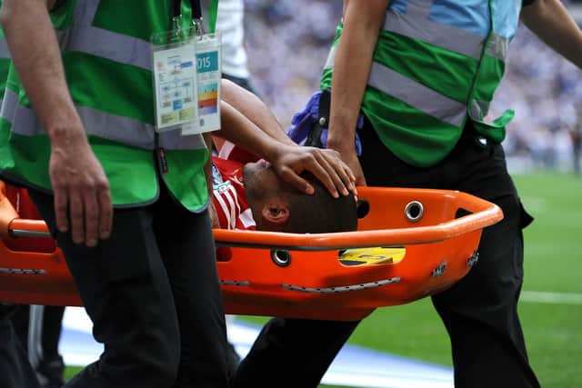Former Swindon defender Nathan Thompson leaves the pitch on a stretcher after getting injured during the League One play-Off final at Wembley