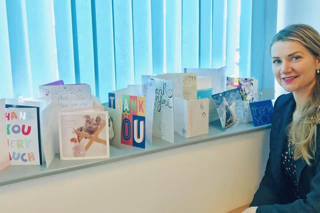 GBS UK Immigrations Victoria Girsa with thank-you cards from grateful clients.