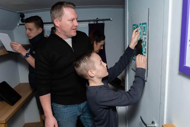 The Wilson family from Havant try to solve a puzzle. They are, from left, Jack (15), dad Shaun, mum Nicky and Charlie (9). Picture: Vernon Nash (060419-027)