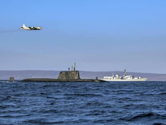 An Astute-class nuclear submarine in company of Portsmouth-based Type 23 frigate HMS Kent while a German Navy P3 maritime patrol aircraft flies overhead. Photo: Royal Navy