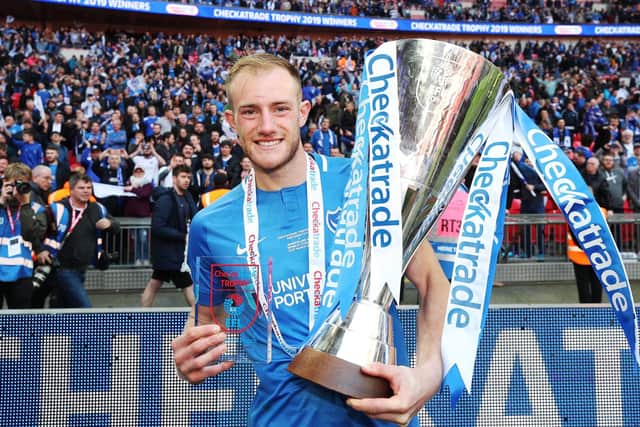 Matt Clarke celebrates Pompey's Wembley victory with the Checkatrade Trophy and his man-of-the-match award. Picture: Joe Pepler