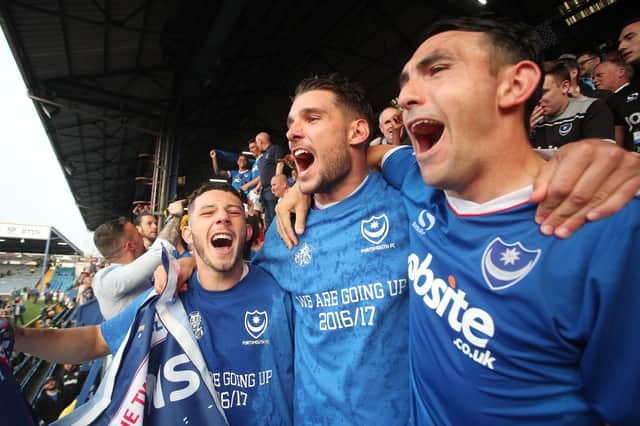 Gareth Evans celebrates with Conor Chaplin and Gary Roberts after clinching the League Two title at Fratton Park in May 2017. Picture: Joe Pepler/Digital South
