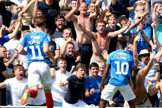 Jamal Lowe celebrates with the Fratton faithful during Pompey's curtain-raiser victory over Luton. Picture: Andrew Fosker