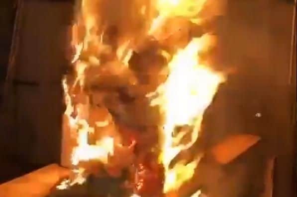 A man has been charged over a video posted on social media of a model of Grenfell Tower being burned over a fire. Picture: PA/PA Wire