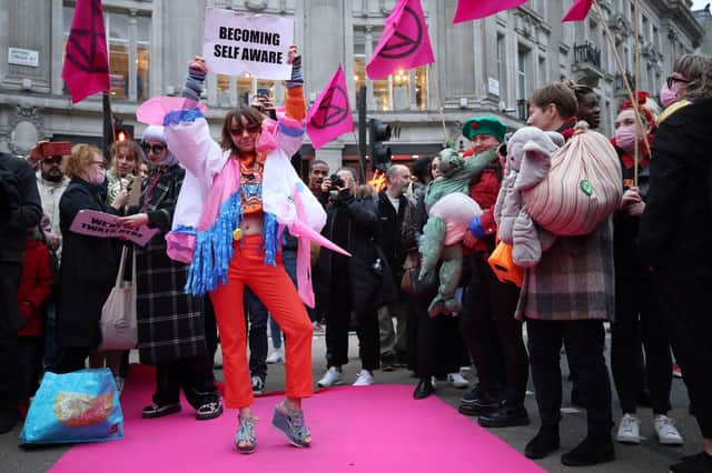 Models and performers take part in the Extinction Rebellion's Fashion: Circus of Excess catwalk in Oxford Circus, London, to highlight the wasteful and disposable nature of the fashion industry.