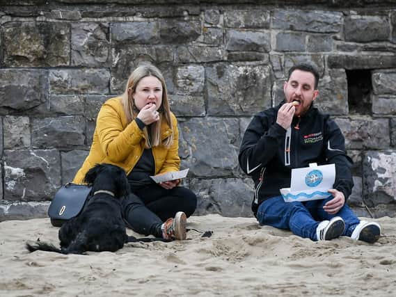 People eat fish and chips. Picture: Ben Birchall/PA Wire