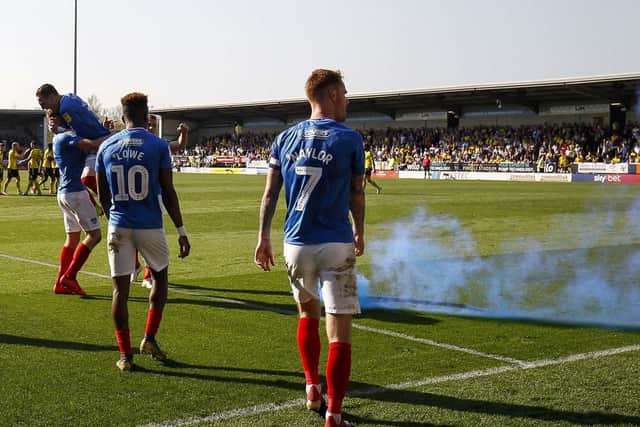 Smoke from the pyro can be seen on the Pirelli Stadium pitch while Pompey celebrate Matt Clarke's winner. Picture: Daniel Chesterton