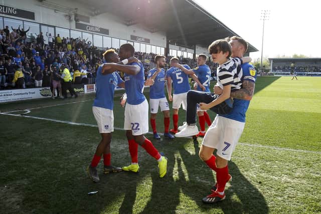 Tom Naylor celebrates with a young fan after Matt Clarke's winner at Burton. Picture: Daniel Chesterton/phcimages.com