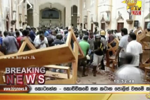This image made from video provided by Hiru TV shows damage inside a church after a blast in Colombo, Sunday, April 21, 2019. Near simultaneous blasts rocked three churches and three hotels in Sri Lanka on Easter Sunday.(Hiru TV via AP)