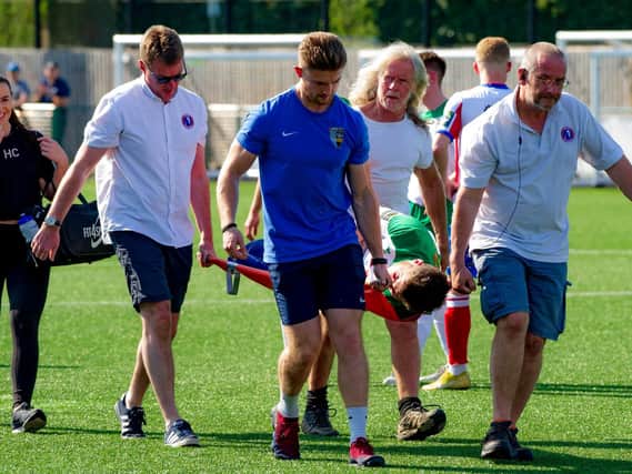 Bradley Lethbridge is stretchered off during Bognor's defeat at Dorking Wanderers. Picture: Tommy McMillan