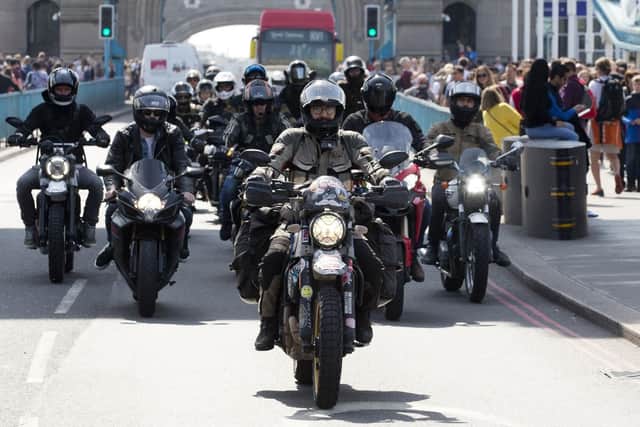 Henry Crew (centre) and supporters arrive on Tower Bridge in London as he breaks Guinness World Record to become the youngest person to circumnavigate the world on a motorcycle. Photo: Isabel Infantes/PA Wire
