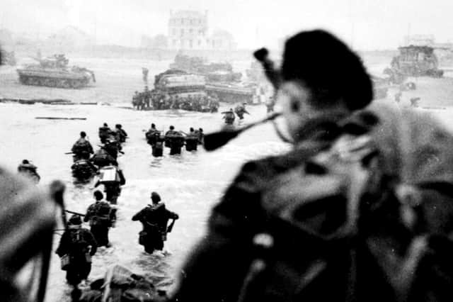 COURAGE: Troops wade ashore on D-Day