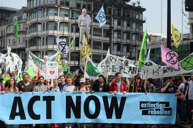 Extinction Rebellion protesters march from their camp in Marble Arch down Park Lane in London.