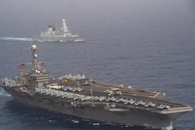 HMS Duncan behind the aircraft carrier USS John C. Stennis in the Mediterranean this week Picture: US Navy Mass Communication Specialist 3rd Class Grant G. Grady