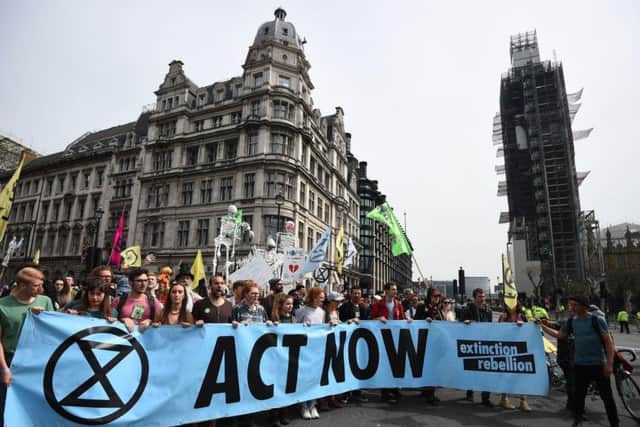 Extinction Rebellion protesters reach their final destination of Parliament Square in Westminster after marching from their camp at Marble Arch, London. More than 1,000 people have been arrested during the climate change protests in London as police cleared the roadblocks responsible for disruption in the capital.