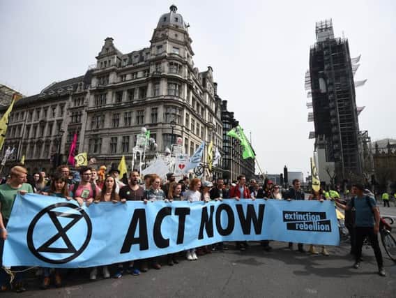 Extinction Rebellion protesters reach their final destination of Parliament Square in Westminster after marching from their camp at Marble Arch, London. More than 1,000 people have been arrested during the climate change protests in London as police cleared the roadblocks responsible for disruption in the capital.