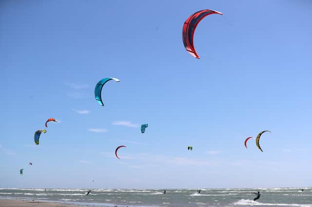 Kite surfers enjoy the strong winds on West Wittering beach in West Sussex on Friday Picture: Andrew Matthews/PA Wire