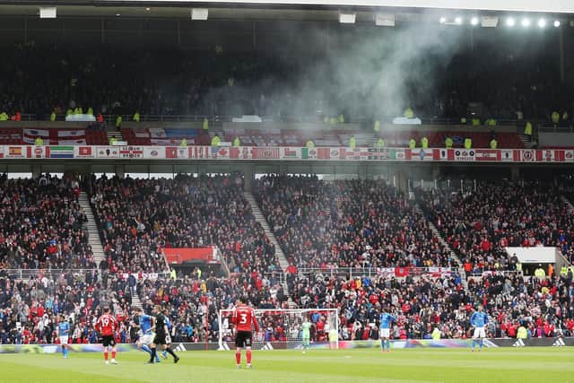 A pyrotechnic is thrown by a Pompey supporter into a Sunderland section following Jamal Lowe's 24th-minute equaliser. Picture: Joe Pepler