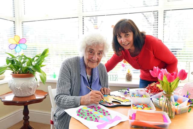 Pat Holloway, left, enjoying doing her artwork with June Conn at The Lodge adult day care centre in Portsmouth. Picture: Malcolm Wells