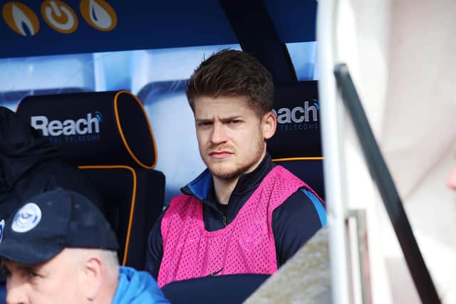 Lloyd Isgrove watches from the bench at Shrewsbury in March - his last involvement in a Pompey first-team squad. Picture: Joe Pepler