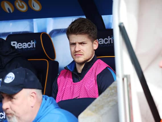 Lloyd Isgrove watches from the bench at Shrewsbury in March - his last involvement in a Pompey first-team squad. Picture: Joe Pepler