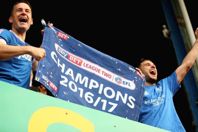 Michael Doyle and Gareth Evans celebrate the League Two title - two years on and Pompey's ex-captain is fighting to keep Notts County in the Football League. Picture: Harry Murphy/Getty Images