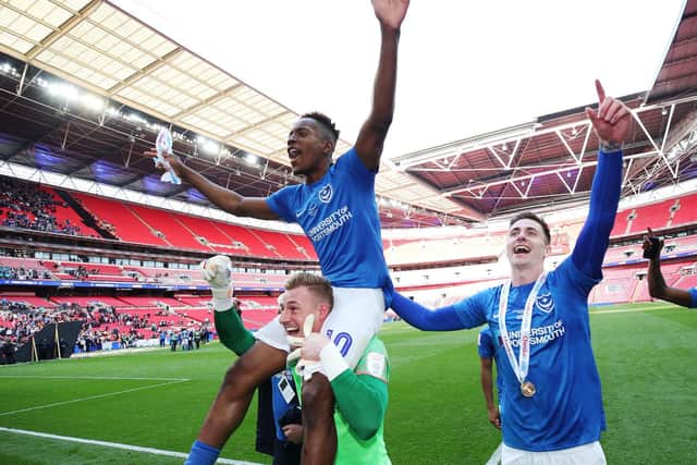 Craig MacGillivray, Jamal Lowe and Oli Hawkins celebrate Pompey's Checkatrade Trophy triumph. Picture: Joe Pepler