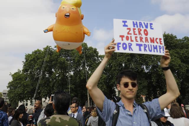 Protesters gather around a giant balloon depicting US President Donald Trump as an orange baby in July last year Picture: Tolga Akmen/AFP/Getty Images