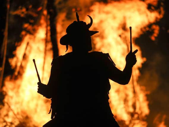 A member of the Pentacle Drummers is silhouetted in front of the burning wickerman during the Beltain Festival, an ancient Celtic celebration to mark the beginning of summer, at Butser Ancient Farm, Waterlooville, Hampshire. PRESS ASSOCIATION Photo. Picture date: Saturday May 4, 2019. Photo credit should read: Andrew Matthews/PA Wire