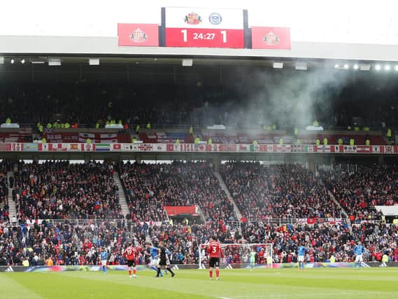 A flare is thrown by a Pompey supporter during the Blues' last visit to the Stadium of Light