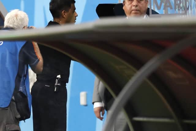 Referee Enrique Caceres watches the VAR during the group B match between Iran and Portugal at the World Cup last year. (AP Photo/Pavel Golovkin)