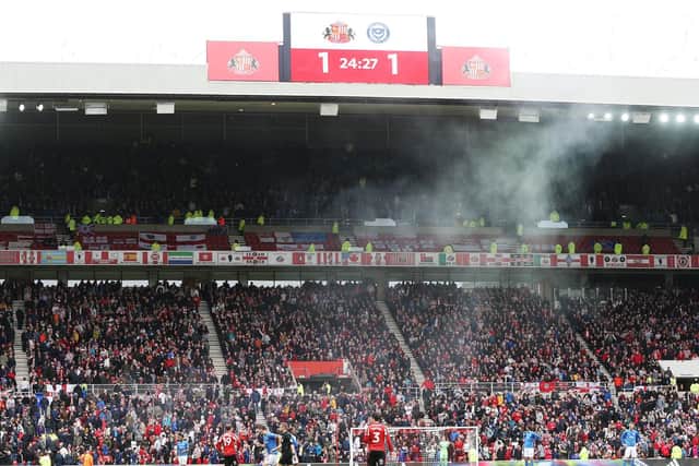 A flare is thrown by a Pompey supporter in the 1-1 draw with Sunderland last month.