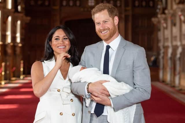 The Duke and Duchess of Sussex with their baby son, Archie, during a photocall in St George's Hall at Windsor Castle. Photo credit: Dominic Lipinski/PA Wire