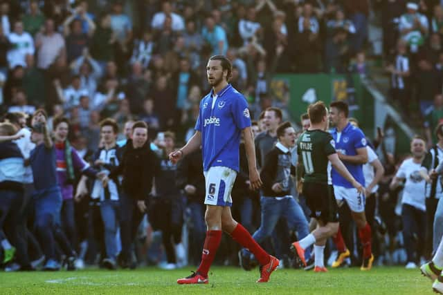 Christian Burgess was consoled by Peter Hartley after Pompey's play-off defeat to Plymouth. Picture: Joe Pepler