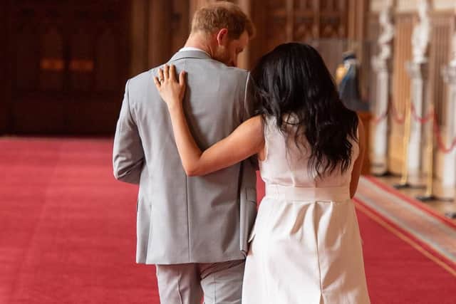 The Duke and Duchess of Sussex walk away with their baby son following a photocall at Windsor Castle.