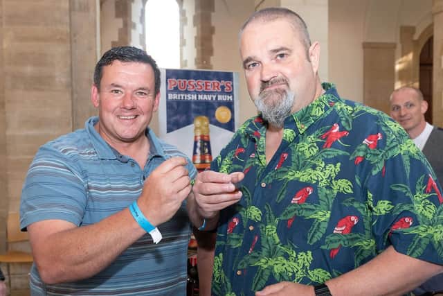 Pictured is: Lee Neale and Garfield Reynolds enjoying a bit of Pussers rum.

Picture: Keith Woodland (110519-6)