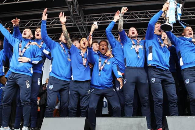 Michael Doyle lifts the League Two trophy as Pompey celebrate the title win. Picture: Joe Pepler