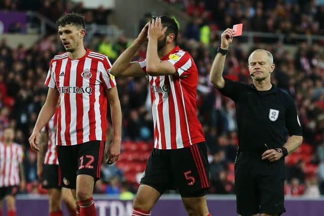 Referee Andy Whoolmer shows Alim Ozturk a red card at the Staium of Light