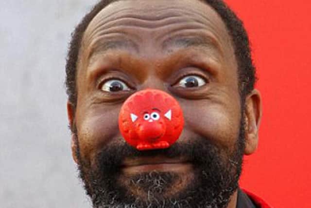 Photocall at The Royal Festival Hall to celebrate 25 years of Comic Relief. Lenny Henry plays to the cameras.