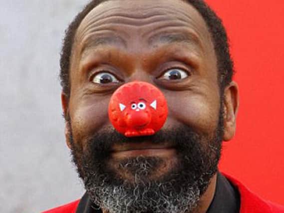 Photocall at The Royal Festival Hall to celebrate 25 years of Comic Relief. Lenny Henry plays to the cameras.