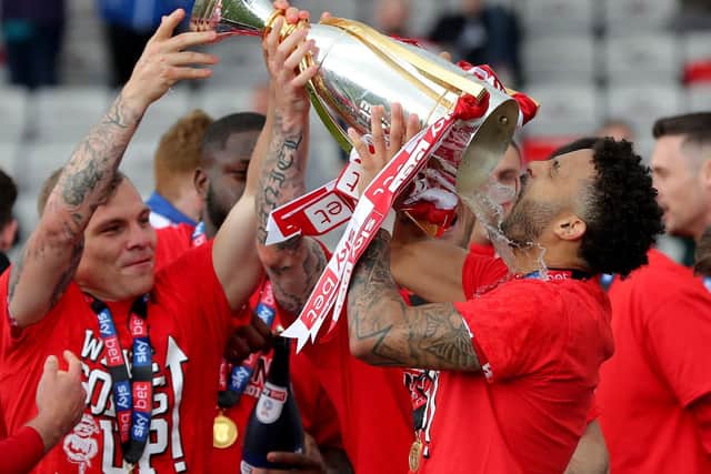 Lincoln City's Bruno Andrade gets covererd in champagne after the Sky Bet League Two match at Sincil Bank, Lincoln. Picture: Richard Sellers/PA Wire
