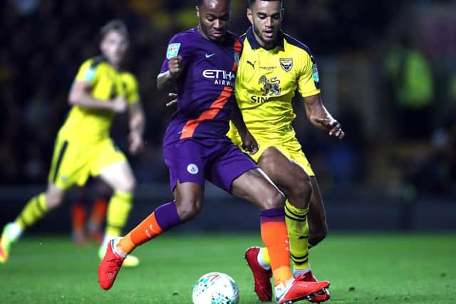 Curtis Nelson challenges Raheem Sterling during Oxford's Carabao Cup defeat to Manchester City earlier this season. Picture: Julian Finney/Getty Images