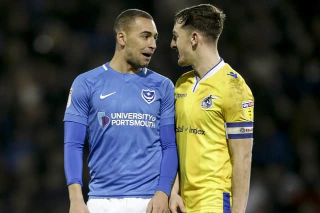 Tom Lockyer, right, squares up to on-loan Pompey striker James Vaughan Picture: Robin Jones