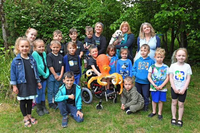 Tommy Chambers at his school, Bedenham Primary School on a 'dress down' dayg to promote awareness of of Tommy's condition as he has an inoperable brain tumour. 
Tommy (centre) with his school friends, teachers, headteacher, his Mum Chelsea Fitton and brother George