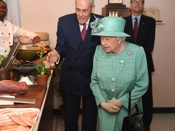 Queen Elizabeth II views goods on display in a replica of one of the original Sainsbury's stores during a visit to Covent Garden, London. Picture: Jeremy Selwyn/Evening Standard/PA Wire