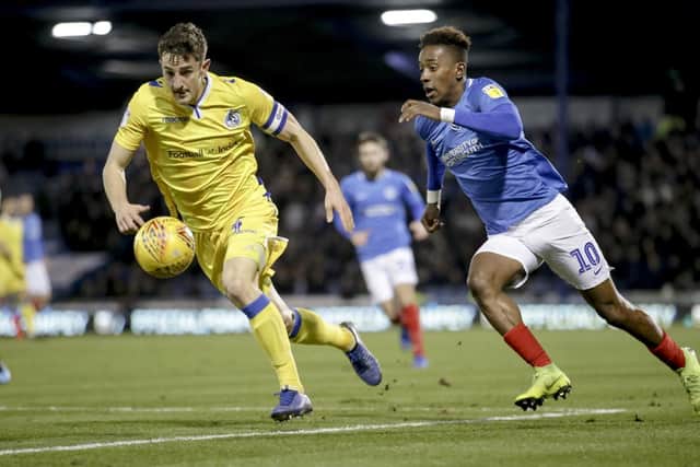 Tom Lockyer battles Pompey's Jamal Lowe for the ball. Picture: Robin Jones