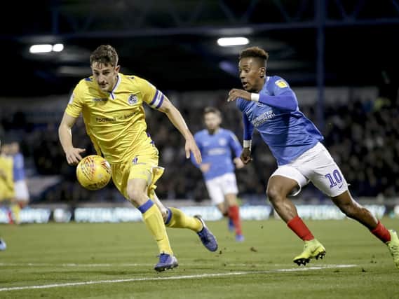 Tom Lockyer battles Pompey's Jamal Lowe for the ball. Picture: Robin Jones